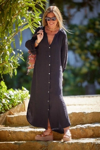 Detail of black cotton linen maxi dress buttons and texture in natural sunlight