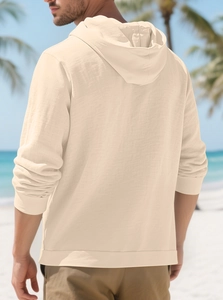Detail view showing textured linen fabric and hood of a beige men's casual beach shirt