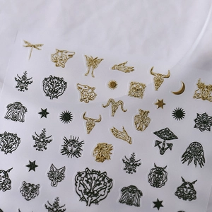 Vintage gold and black embossed nail art stickers with butterfly and mystic sun patterns