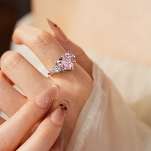 Detailed close-up of a heart-shaped pink gemstone ring with zircon crown star accents