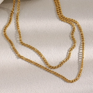 Detail shot of 18K gold plated Figaro chain necklace with high polish finish and texture