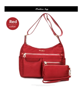Detail of red water-resistant nylon shoulder bag and matching small pouch set