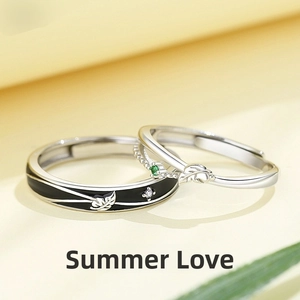 Detail of adjustable angel and devil rings with black enamel and green gemstone accents