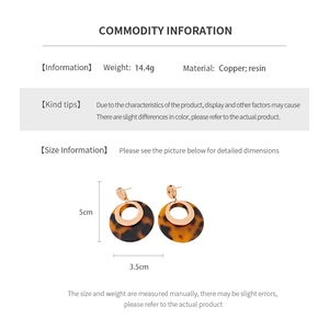 Detail showing resin hoop earrings with dimensions 5cm by 3.5cm and gold plating