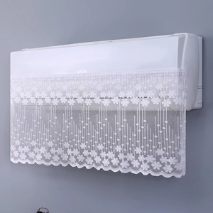 Detailed close-up of white lace air conditioner cover with floral embroidery and wavy edges