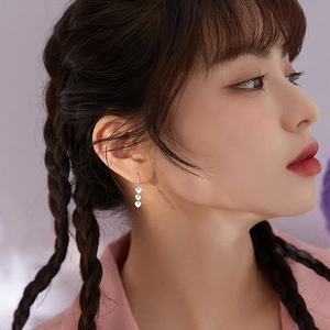 Three-tier silver heart pendant drop earrings shown on model for stylish look