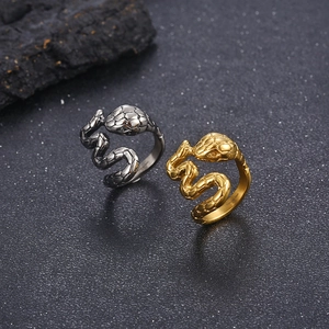 Detailed close-up of snake wrap rings in gold and silver showing textured scales