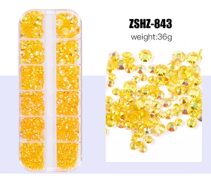 Detail view of yellow AB colorful flatback resin rhinestones in a 12-grid storage box