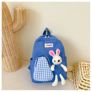 Blue kids backpack with blue and white plaid pocket and a white plush bunny charm