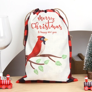 Christmas drawstring gift bag with cardinal bird and red plaid accents on canvas