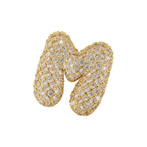 Macro shot of gold-plated letter N pendant with sparkling cubic zirconia inlay