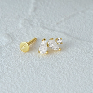 Macro shot of S925 sterling silver gold stud earrings with teardrop and round clear gems