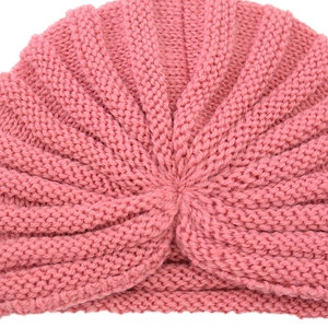 Pink bohemian knit turban hat for women featuring a stylish knotted twist and soft ribbed texture