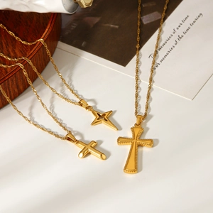 Three 18k gold plated stainless steel necklaces featuring cross and star pendants