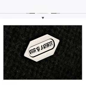 Detailed view of silver BEST SPORT metal emblem on thick black wool baseball cap