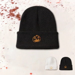 Detailed view of Jack-o'-lantern pumpkin embroidery on knit beanie for Halloween