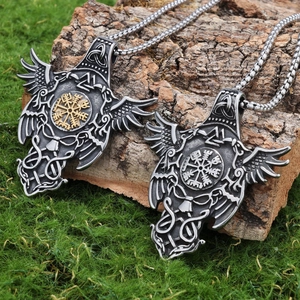 Viking raven pendant necklace with Nordic runes on natural wood bark and green grass