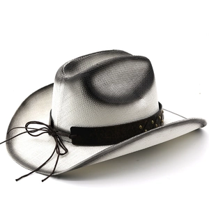 Detail of western cowboy straw hat with black gradient edge and studded leather band