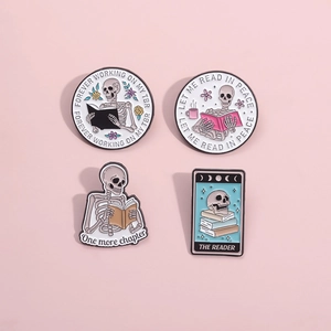 Set of four unique skull enamel pins featuring reading themes and library motifs