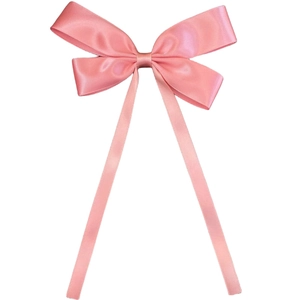 Close-up of pink satin ribbon bow hair clip with elegant long streamers on white background