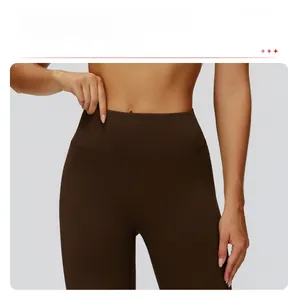 Macro detail of high-waist brown yoga pants showing seamless front design and elastic fabric