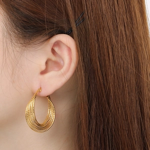 Gold twist rope hoop earrings in stainless steel, elegant geometric design for women