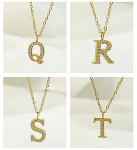Detailed view of gold plated initial necklaces Q, R, S, and T with zircon micro-paving