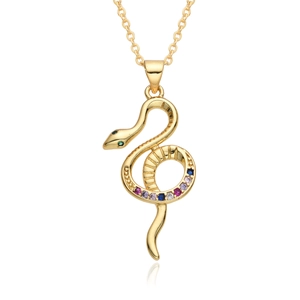 Macro detail of a gold snake pendant with multi-colored zircons and crystal snake eyes