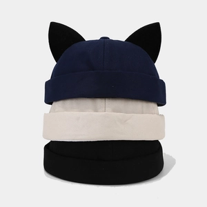 Three Miki hats in navy, beige, and black colors with cute cat ear details on top