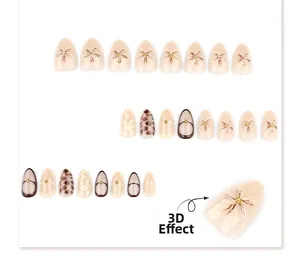 Macro detail of almond press-on nails featuring 3D flowers, leopard print and gold accents