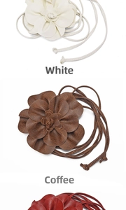 Macro shot of faux leather flower waist rope showing petal textures in white and brown