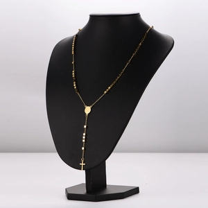 Vintage luxury gold tassel necklace with cross and medallion pendants on black bust