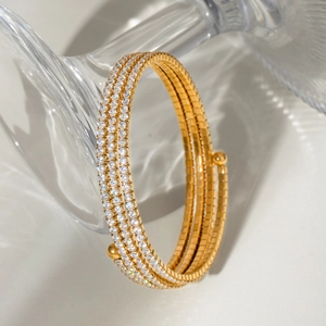 Macro shot of gold-plated triple spiral bracelet with pave-set white cubic zirconia
