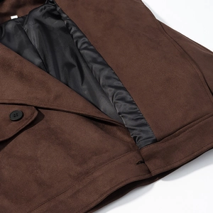 Macro detail of brown faux suede texture with high-quality stitching and black lining