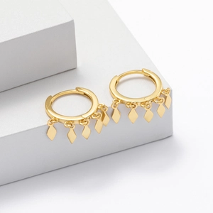 Elegant gold s925 silver hoop earrings with diamond-shaped tassel charms on white cubes
