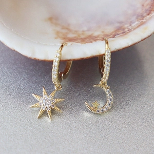 Close-up of luxury S925 asymmetric star and moon hoop earrings with cubic zirconia