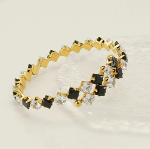 Detail of 18k gold plated stainless steel bracelet with square zircon and black onyx