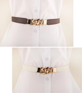 Detail view of elastic waist belts in brown and beige colors with gold chain buckles