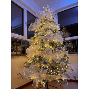 Christmas tree with warm gold mesh ribbon, LED star topper, and festive ornaments