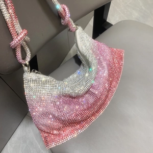 Detailed macro of pink gradient rhinestone handbag with knotted sparkling shoulder strap