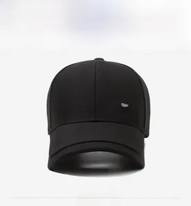 Detail of classic black baseball cap with metallic logo plate on high density twill cotton