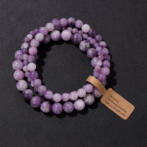 Detailed view of purple gemstone beaded bracelet with nature-inspired kraft paper tag