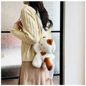 Detail of plush cat backpack with brown heart patch and white adjustable shoulder strap