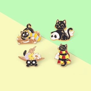 Set of four cute cartoon black cat enamel pins with wizard hat and suitcase motifs