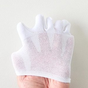 Close-up of white breathable mesh five-toe socks showing the thin knit texture