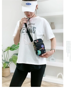 Detail of crossbody phone bag with colorful hot air balloon print and earphone hole