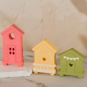 Detailed view of colorful seaside house miniature resin crafts in pink, yellow and green