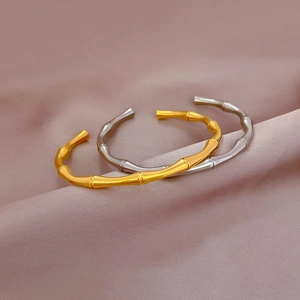 Bamboo style titanium steel open bracelets in gold and silver set on silk fabric
