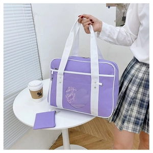 Detail of purple JK uniform ita bag featuring heart-shaped clear PVC window and small coin purse