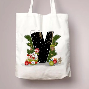 Detail of Christmas canvas tote bag featuring festive letter V with pine and bird motifs